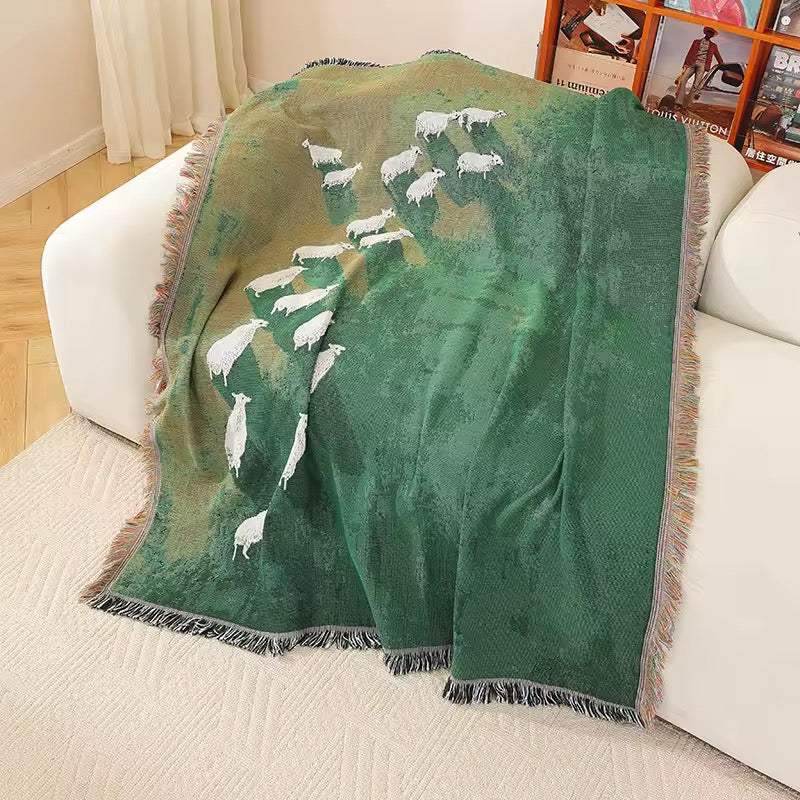Sheep pattern woven blanket styled as a cottagecore tapestry wall hanging.