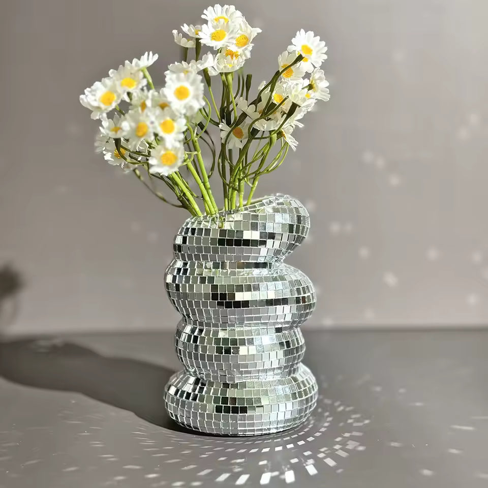 Silver mosaic vase with white flowers on a gray background