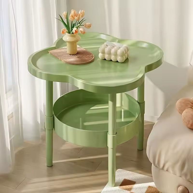 Green four-leaf clover coffee table by the window with flowers and candle decor