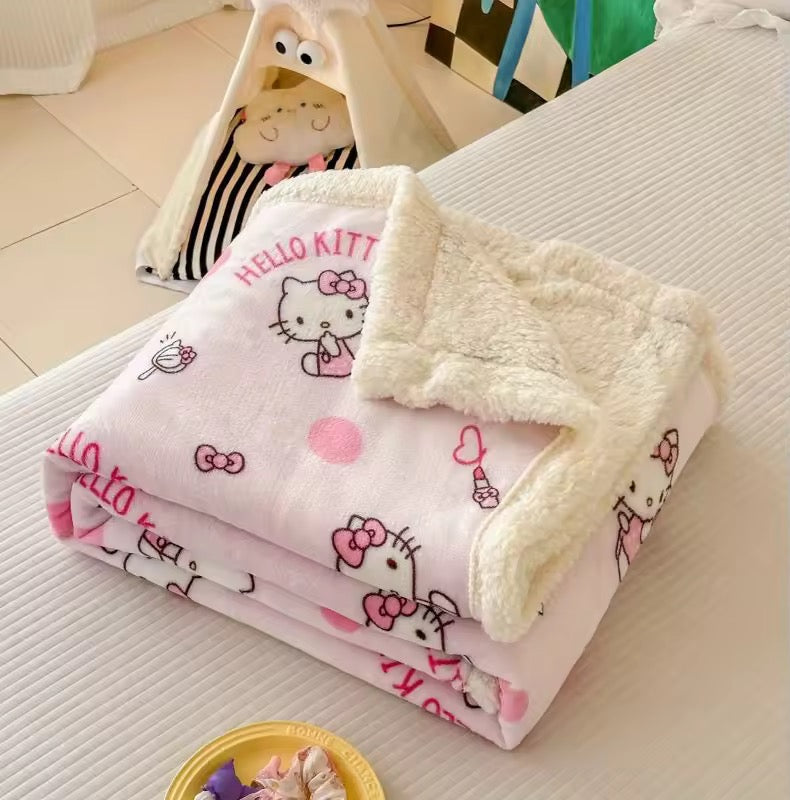 Soft and cute reversible blanket on dorm bed with ruffled pillows.