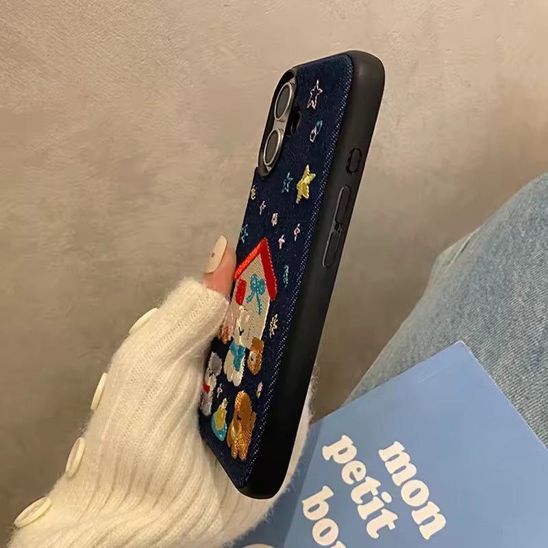 Phone case with cartoon characters held by a person wearing white gloves.