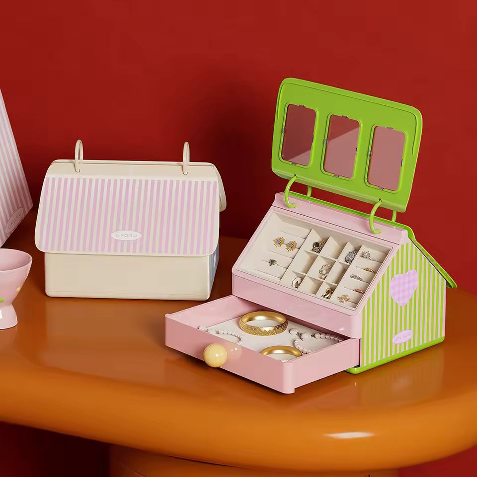Pink jewelry box with green accents on a red background