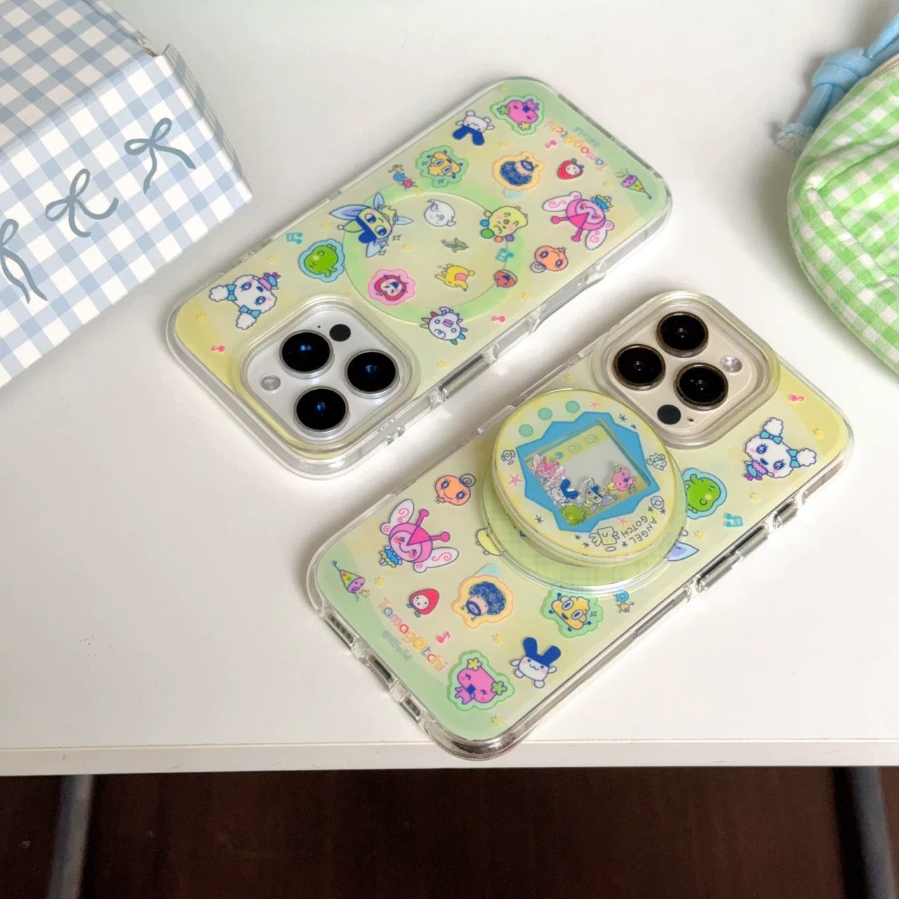 Two phone cases with cartoon designs on a white surface