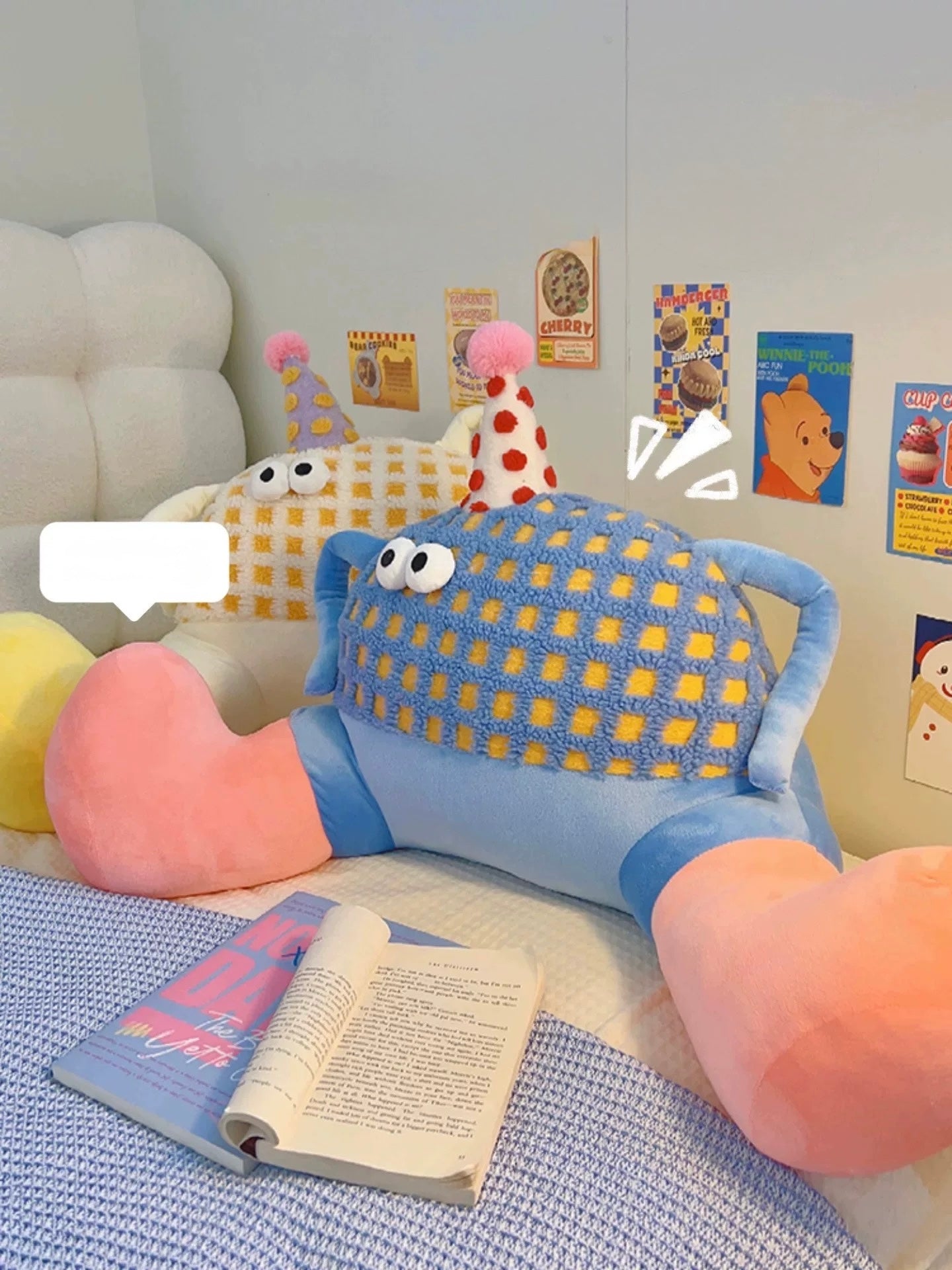 Children's room with plush toys and a book on a bed