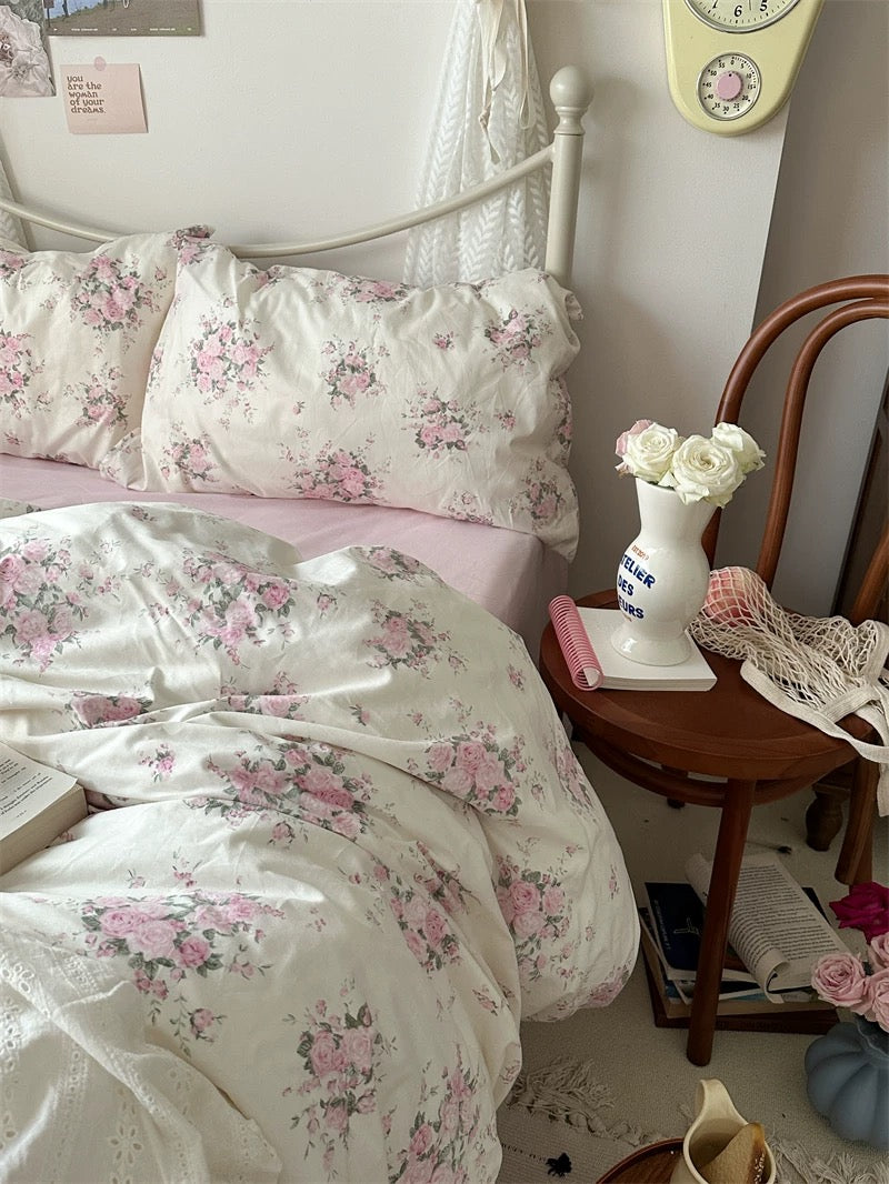 Floral cotton duvet cover layered with blush sheets creating timeless romantic bedroom styling for everyday comfort and relaxation.