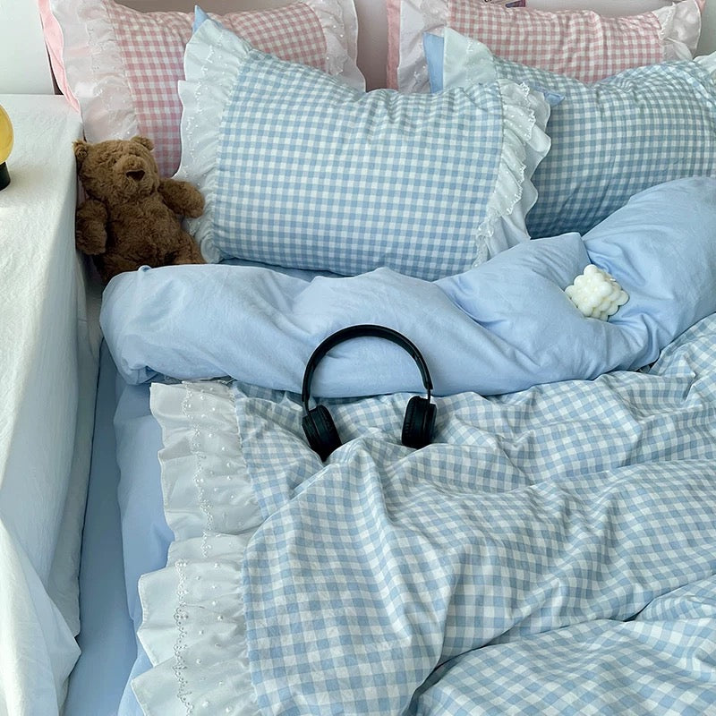 Mint green gingham bedding set with scalloped lace edges on a white bed frame