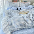 Frilly quilt covers in pastel tones styled with fairy lights and soft rugs