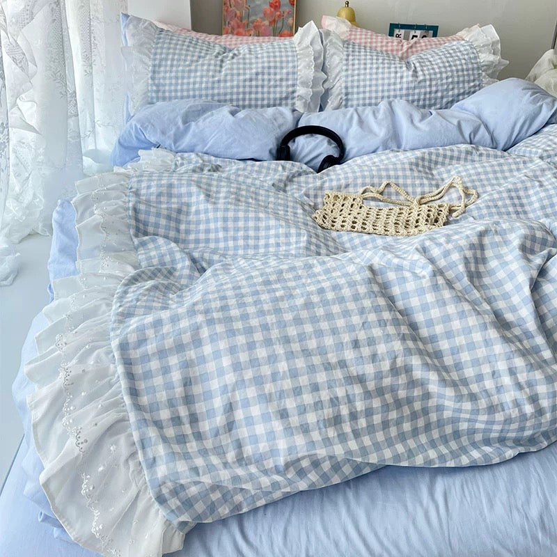 Frilly quilt covers in pastel tones styled with fairy lights and soft rugs