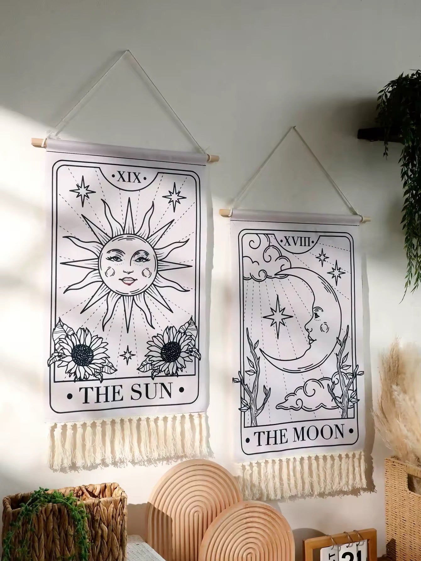 Boho bedroom setup with sun and moon tarot tapestries styled above spiritual objects.