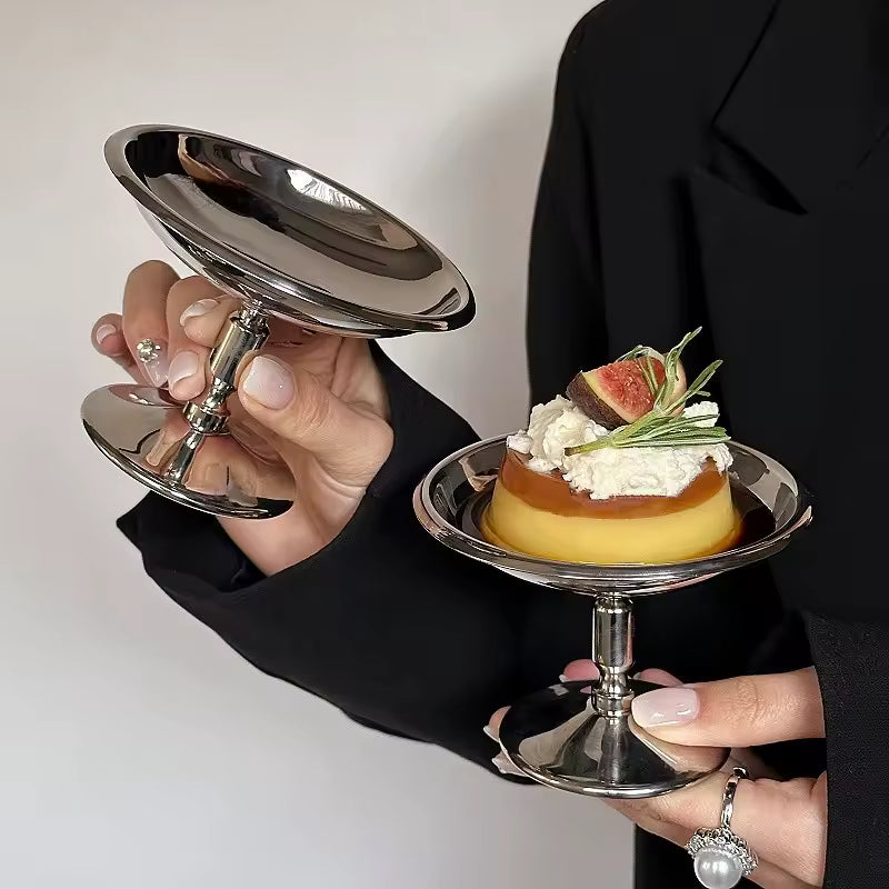 Silver dessert platter with various small dishes of desserts on a white surface.