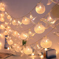 String lights with shell and starfish decorations on a ceiling