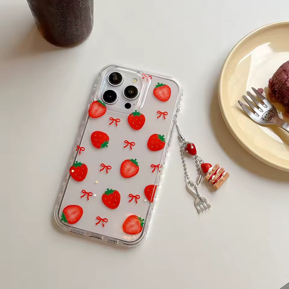 Phone case with strawberry pattern held by a hand on a pink surface