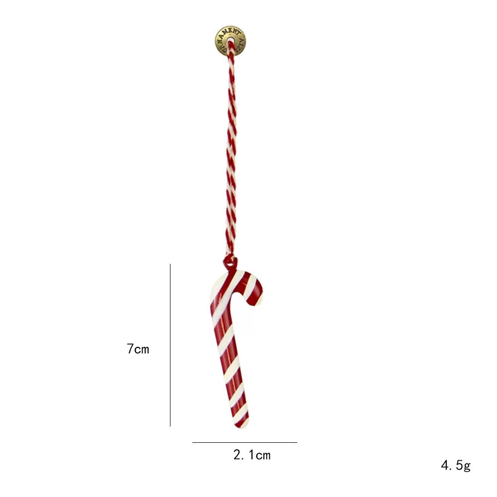 A striped candy cane Christmas ornament has diagonal red and white bands and a matching twisted cord.