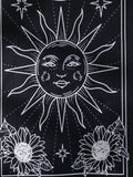 Celestial-themed wall hangings with mystical sun and moon faces in gothic line art style.