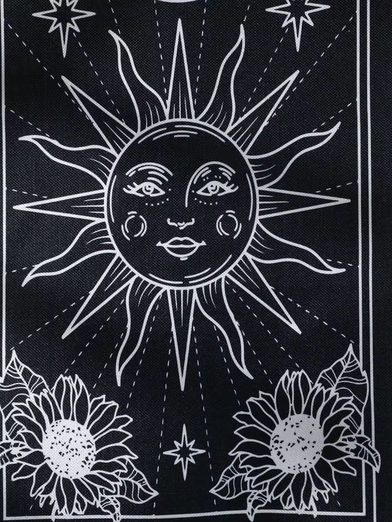 Celestial-themed wall hangings with mystical sun and moon faces in gothic line art style.