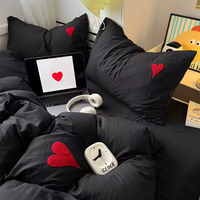 Gothic soft girl bed styled with cozy throw and red heart comforter