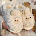Pair of fluffy white slippers with animal face design held by a person.