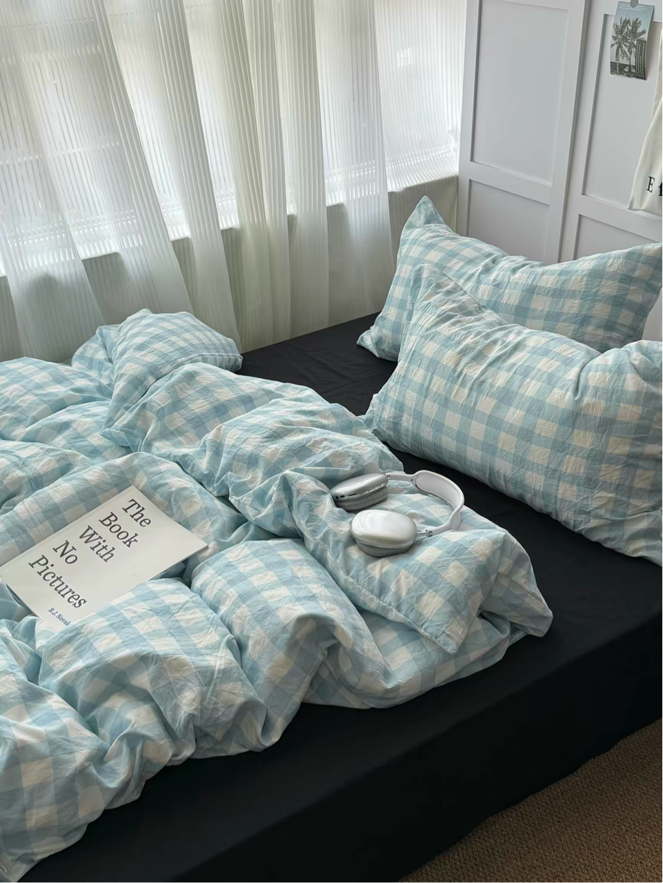 Light blue gingham bedding with a relaxed duvet and black pillow accents