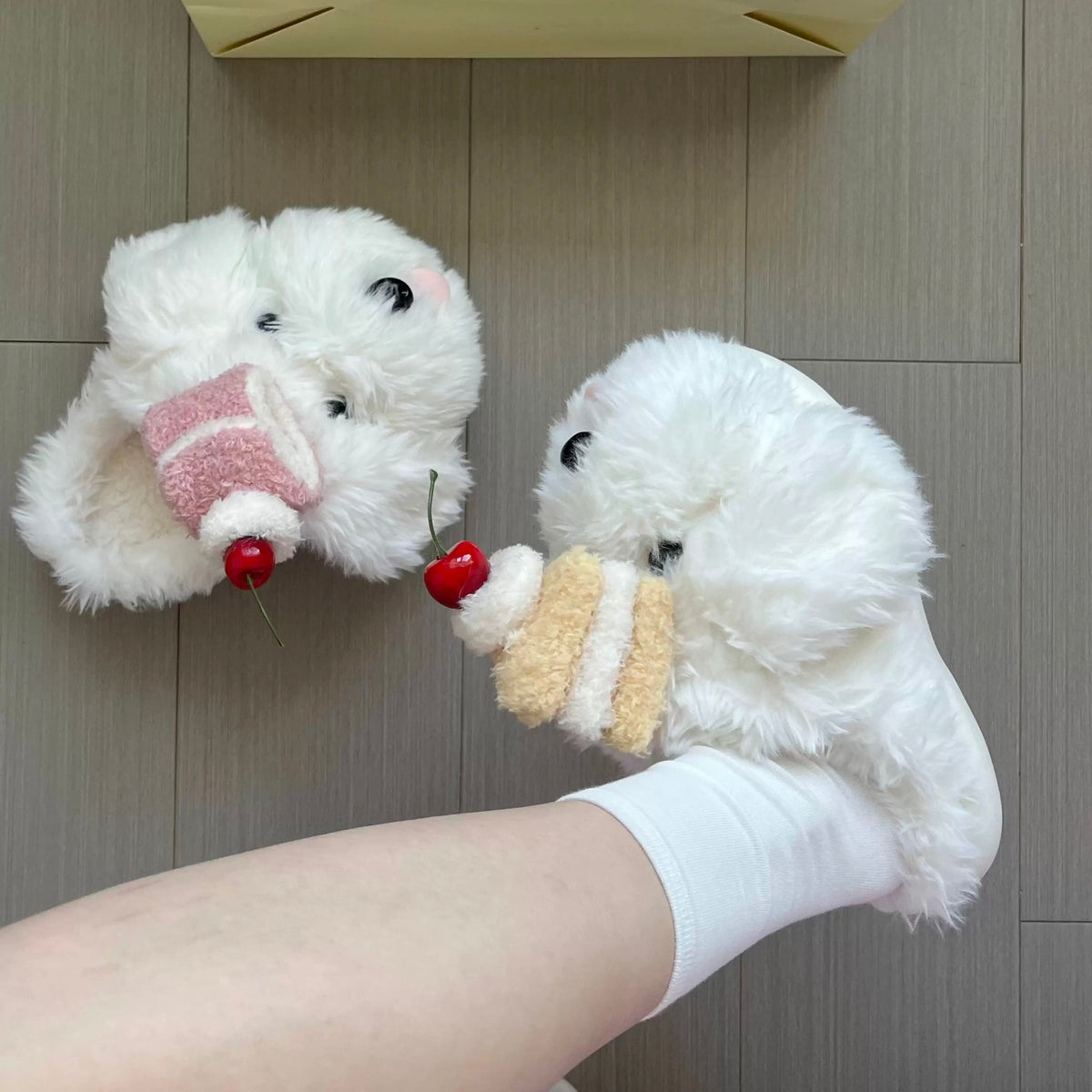 White cherry dog slippers worn indoors with cake details on the puppy faces