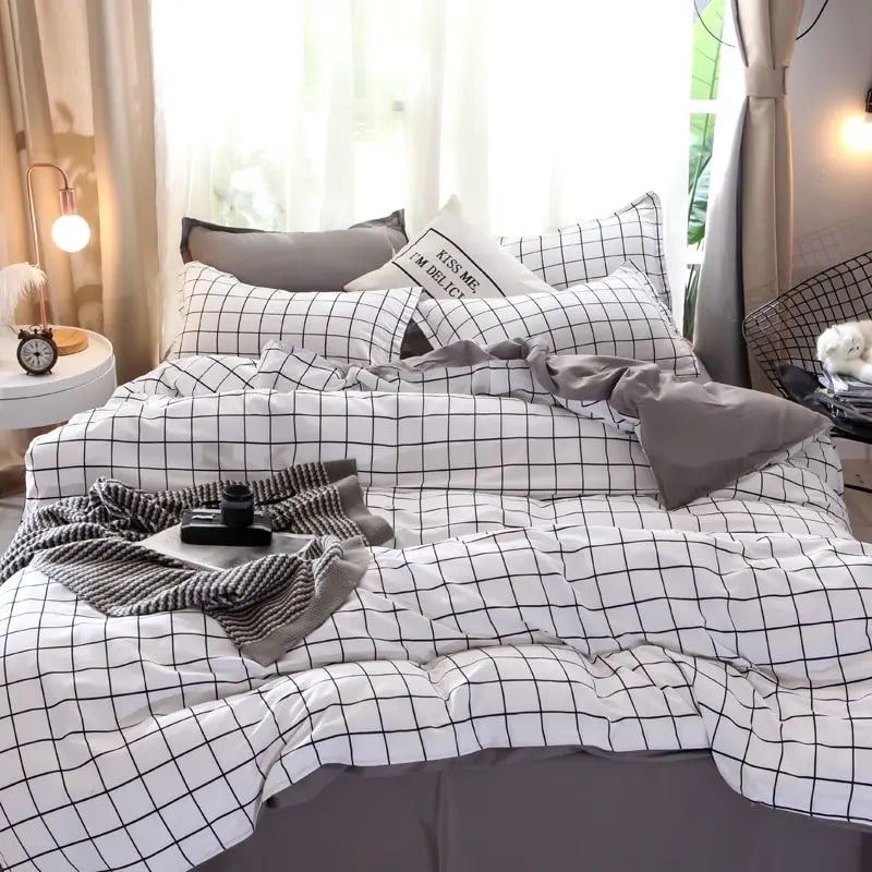 White and gray plaid bedding set styled on a bed