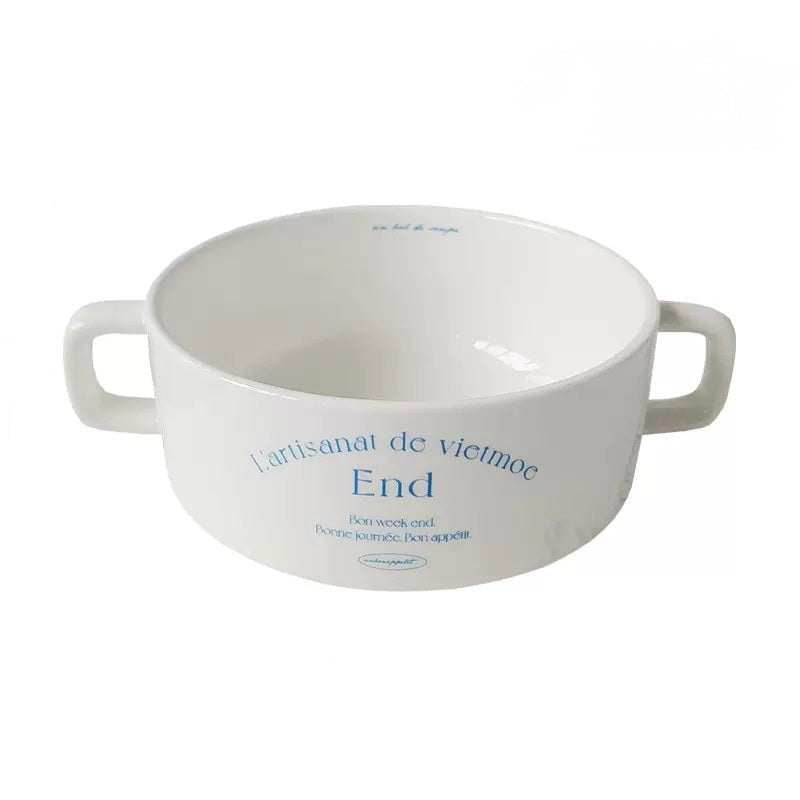 White ceramic plate with narrow blue border French text and smooth slightly raised outer edge