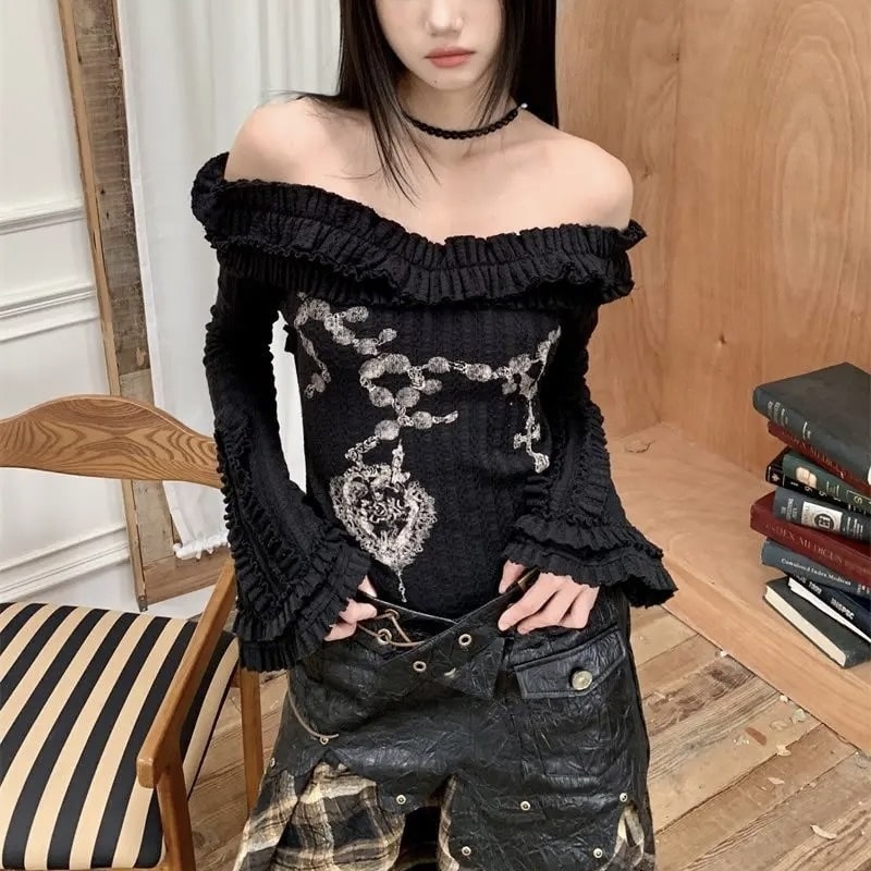 Y2K grunge sweater in black with tattoo print and off-shoulder design. Flare sleeve knitted crop top for Harajuku aesthetic.