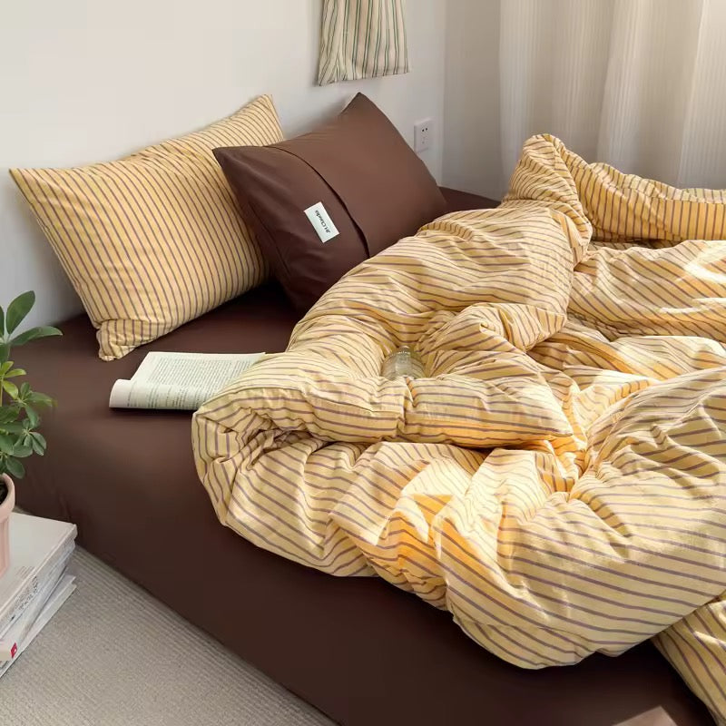 Striped yellow cotton bedding set for modern minimalist home decor.