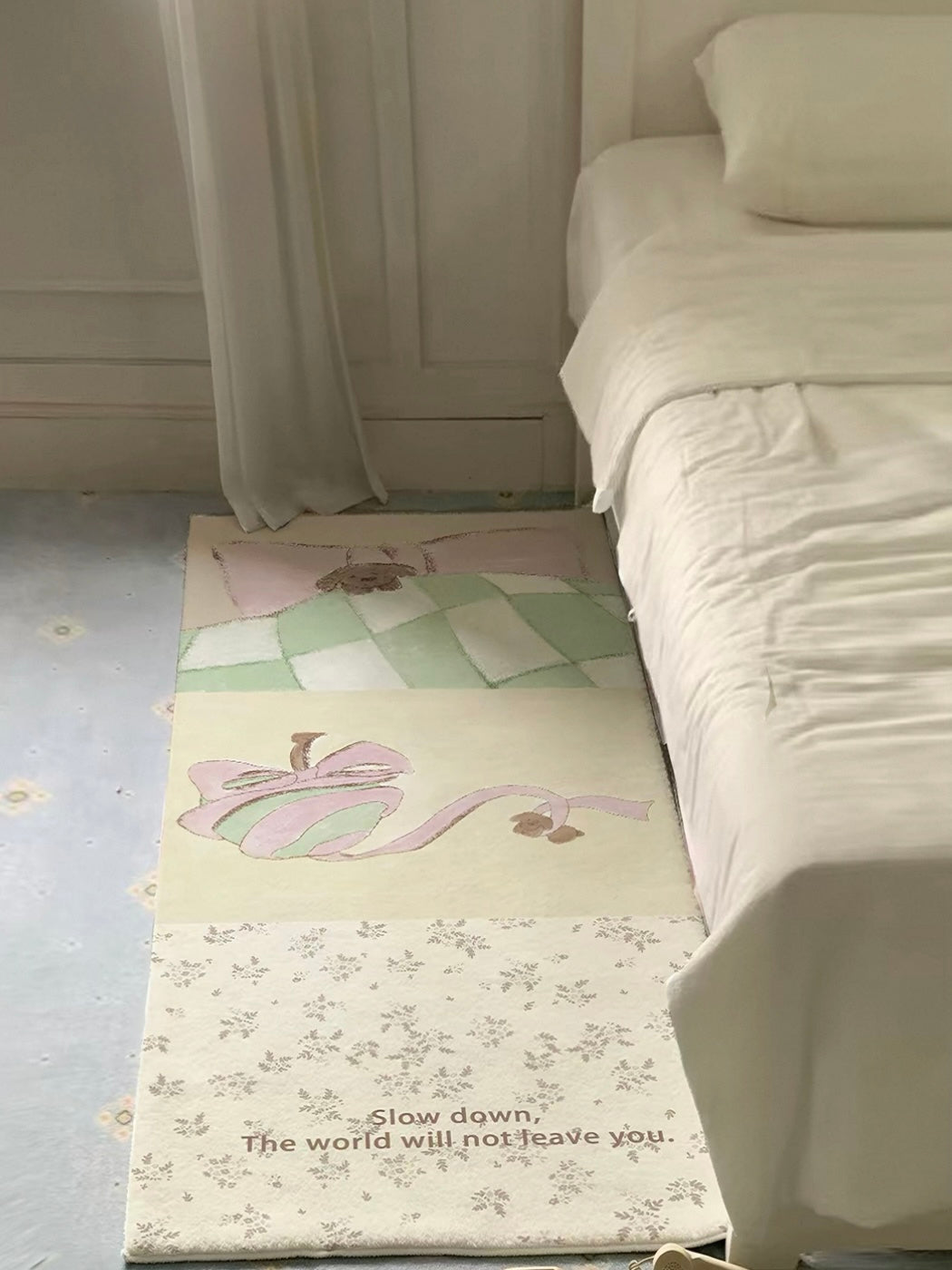 A yellow floral runner rug lies beside a bed, with green checks near the top and tiny flowers at the end.