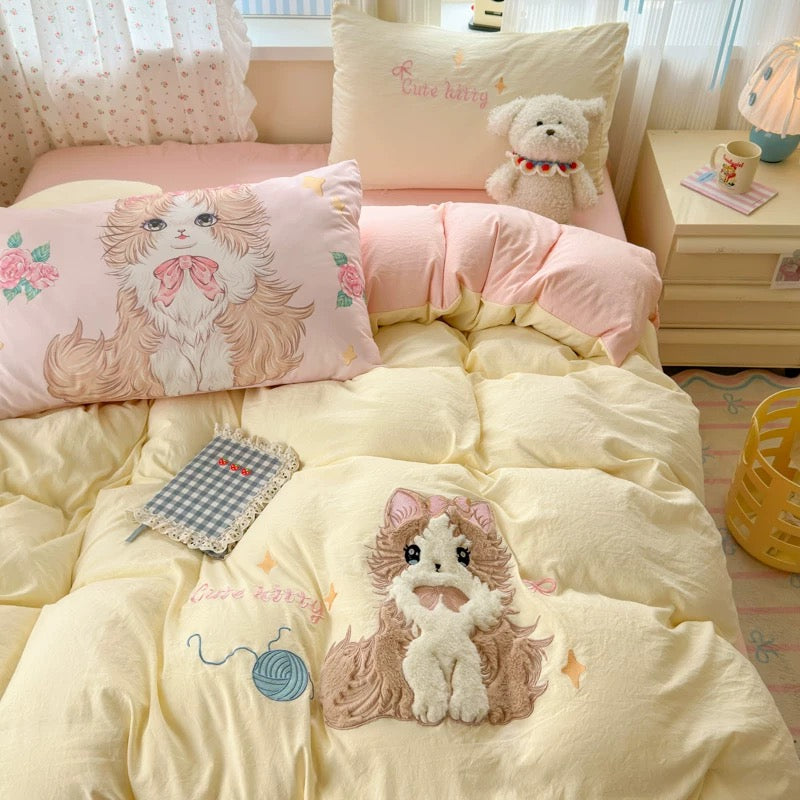 Bed with cartoon-themed bedding and pillows in a bright room.