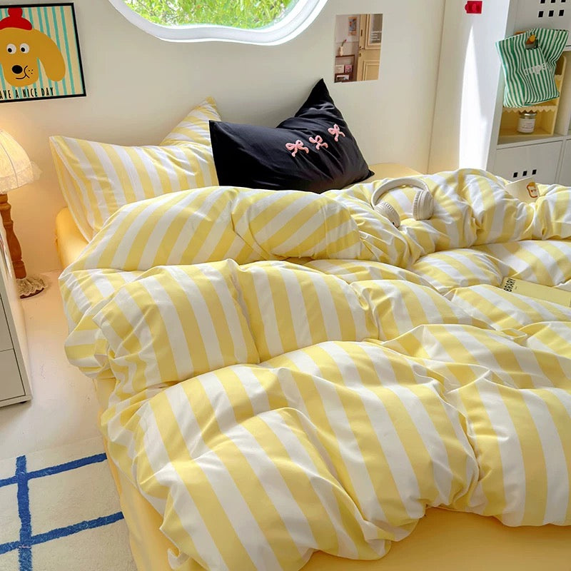 Full view of the 4-piece bedding set, including duvet cover, flat sheet, and two pillowcases.