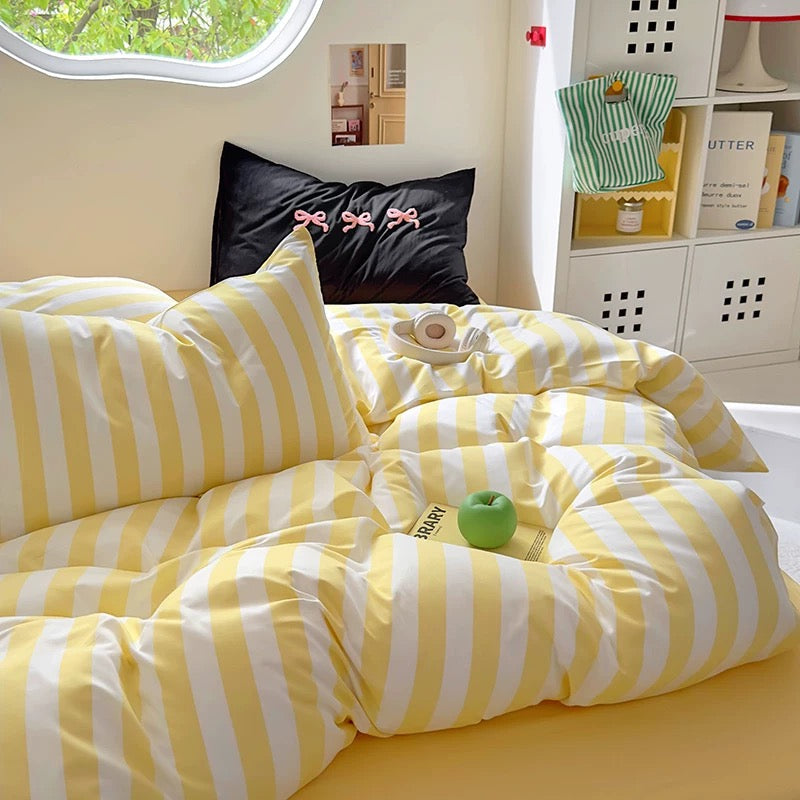 Aesthetic dorm room with the yellow striped bedding set as the focal point.